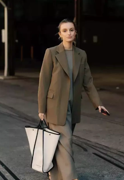 A suit paired with a skirt creates a stylish and elegant look.